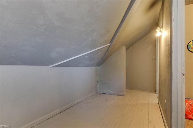 bonus room with vaulted ceiling and wood finished floors