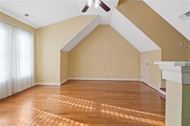 bonus room with a ceiling fan, visible vents, vaulted ceiling, and wood finished floors