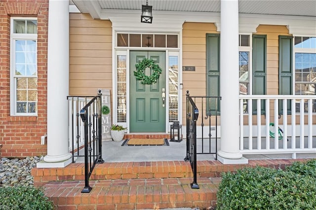 doorway to property featuring brick siding