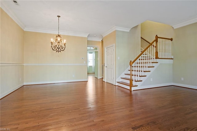 unfurnished room with baseboards, ornamental molding, wood finished floors, stairs, and a notable chandelier