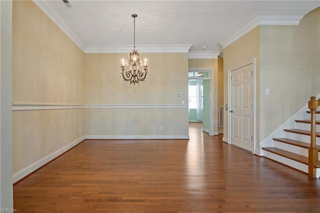 unfurnished room featuring crown molding, wood finished floors, baseboards, stairway, and an inviting chandelier