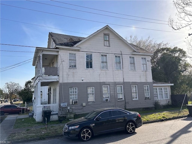 view of property with roof with shingles