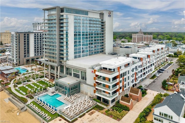 view of building exterior with a community pool and a view of city