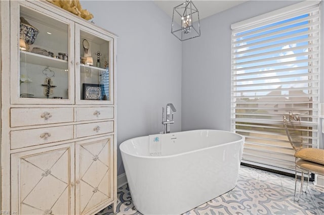 interior space with an inviting chandelier and a freestanding bath