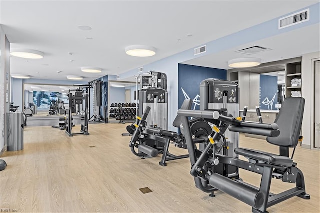 gym with wood finished floors and visible vents