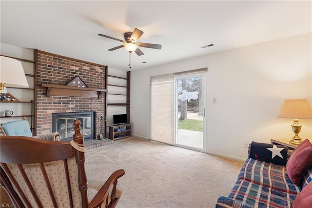 living room featuring carpet, a brick fireplace, visible vents, and baseboards