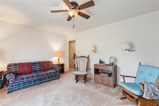 living room with a ceiling fan and carpet flooring