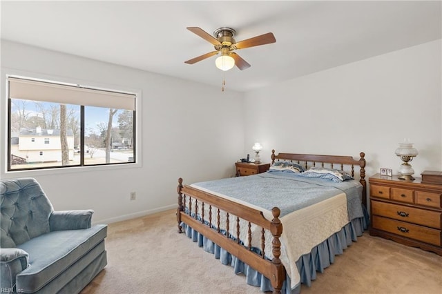 bedroom featuring baseboards, ceiling fan, and light colored carpet