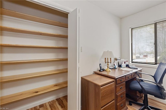 office area featuring light wood-type flooring and baseboards