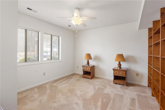 unfurnished room with a ceiling fan, carpet, visible vents, and baseboards