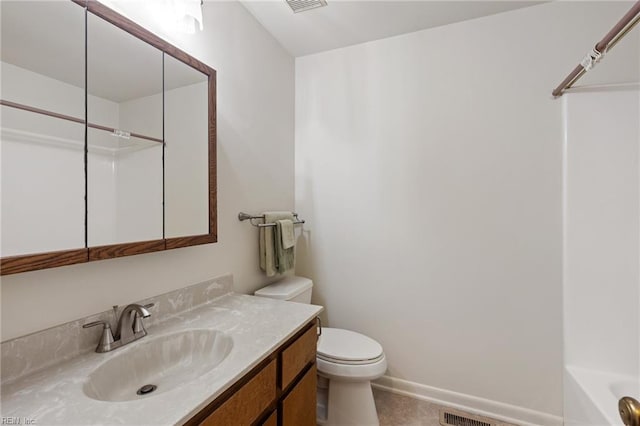 bathroom featuring baseboards, vanity, and toilet