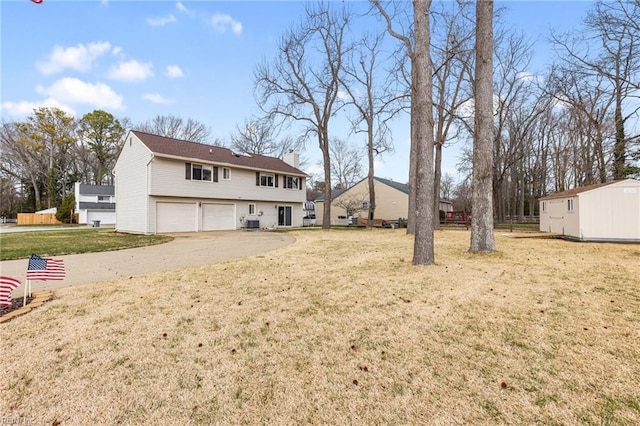 exterior space featuring a garage, driveway, a lawn, and a chimney