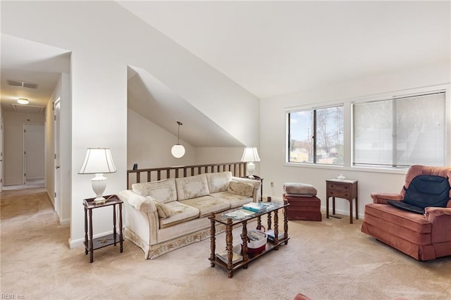 living area featuring visible vents, attic access, light carpet, vaulted ceiling, and baseboards