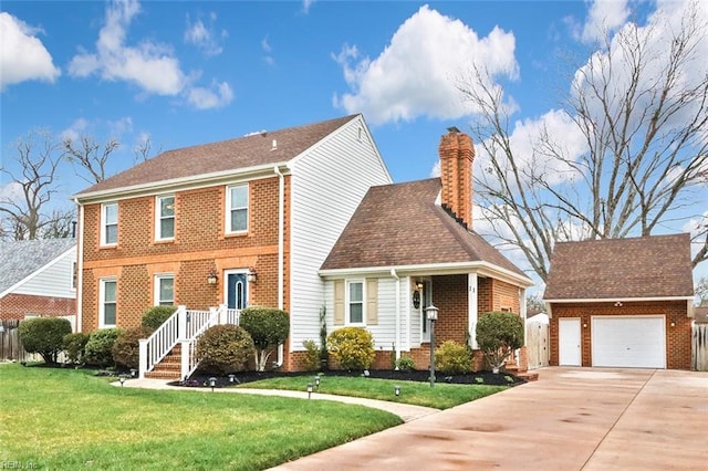 colonial-style house featuring an outbuilding, a front lawn, a chimney, and a garage