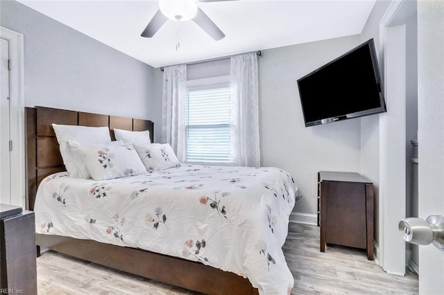 bedroom with baseboards, a ceiling fan, and wood finished floors