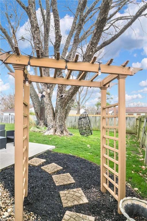 view of yard with a patio area, a fenced backyard, and a pergola