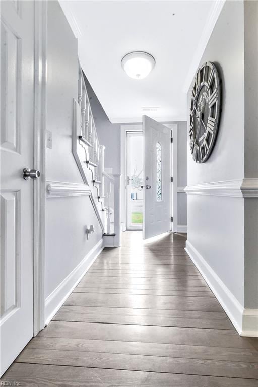 entryway with wood-type flooring, stairway, and baseboards