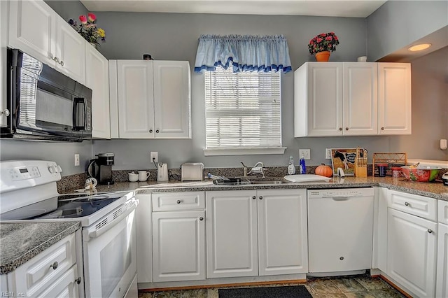 kitchen with white appliances, a sink, and white cabinets