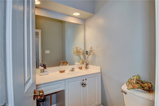 bathroom with toilet and vanity