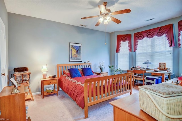 bedroom featuring light carpet, a ceiling fan, visible vents, and baseboards