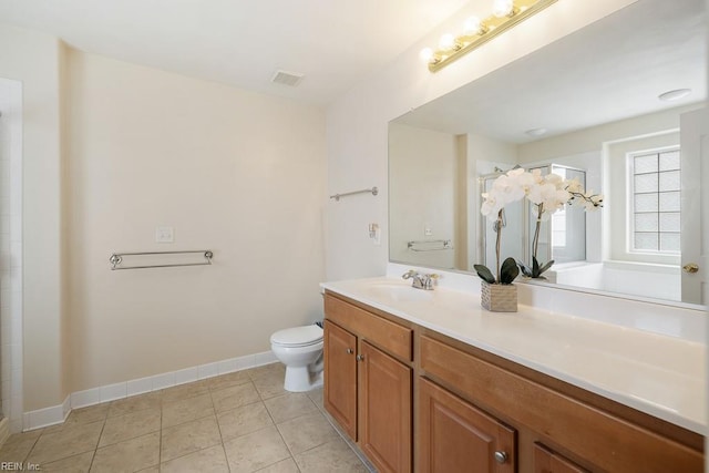 bathroom featuring visible vents, toilet, vanity, tile patterned flooring, and baseboards