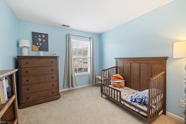 bedroom featuring light carpet, visible vents, and baseboards