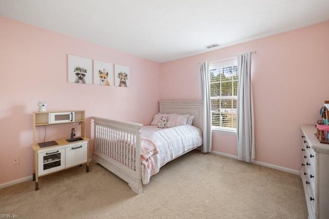 bedroom featuring light carpet, visible vents, and baseboards