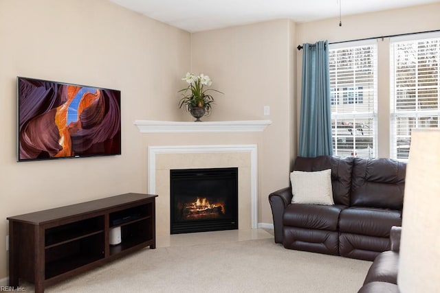 carpeted living area featuring a high end fireplace