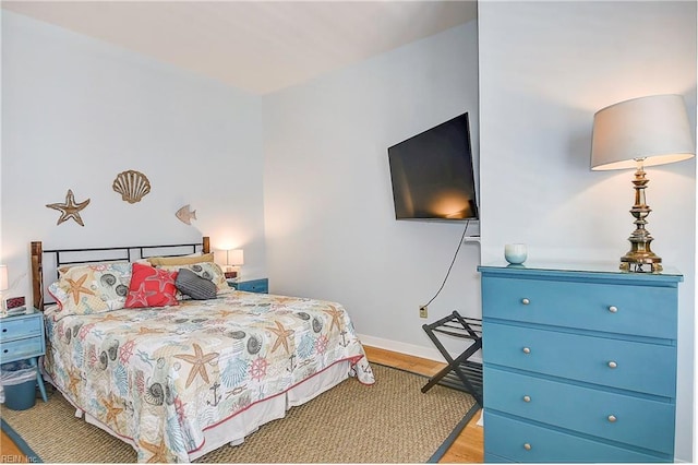 bedroom featuring light wood-style floors and baseboards