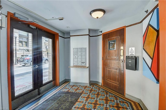 entryway featuring french doors, mail area, baseboards, and tile patterned floors