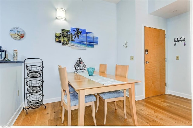 dining area featuring light wood-type flooring and baseboards