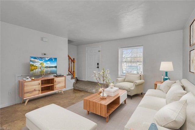 living area featuring stairway and baseboards