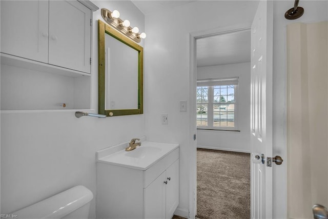 half bathroom with vanity and toilet