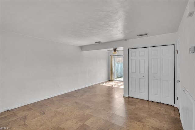 unfurnished bedroom with a closet, visible vents, and baseboards