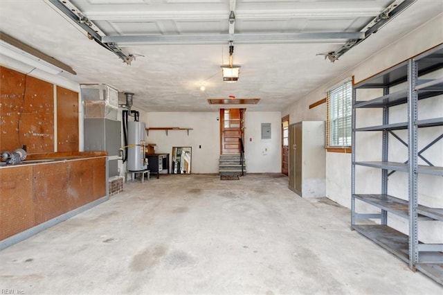 garage featuring electric panel, heating unit, and water heater