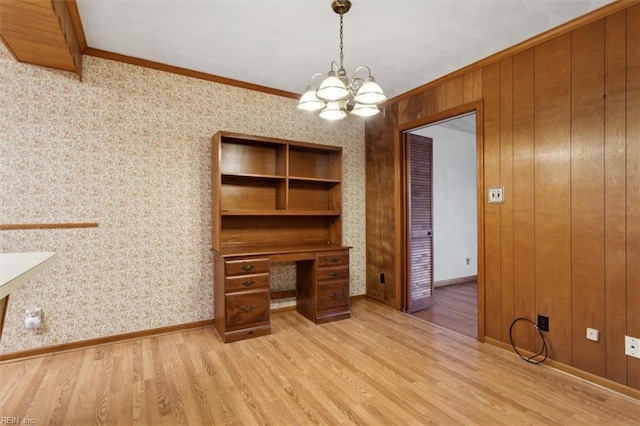 unfurnished office with light wood-type flooring, baseboards, a chandelier, and crown molding