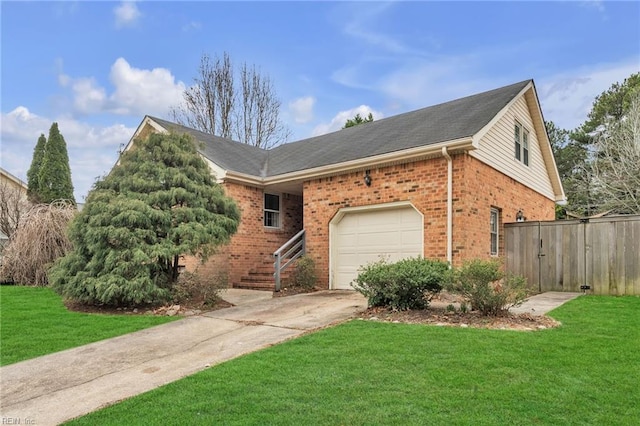 view of front of house featuring driveway, a front yard, and brick siding