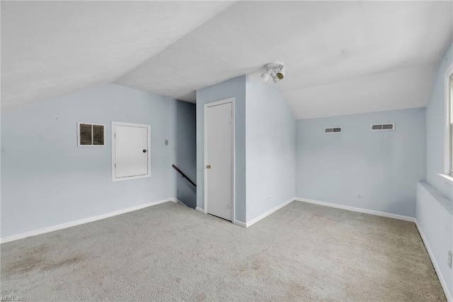 bonus room featuring lofted ceiling and visible vents