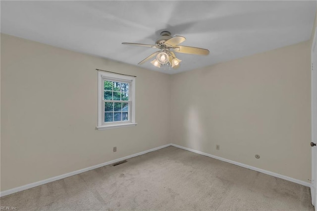 empty room with carpet floors, visible vents, and baseboards