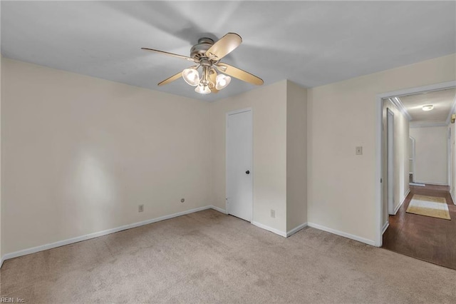 unfurnished bedroom with carpet flooring, a ceiling fan, and baseboards