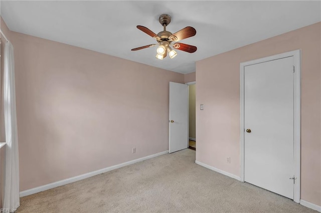 unfurnished bedroom featuring carpet flooring, a ceiling fan, and baseboards