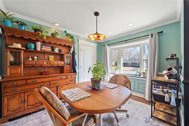 dining room featuring light wood-style flooring, crown molding, and recessed lighting