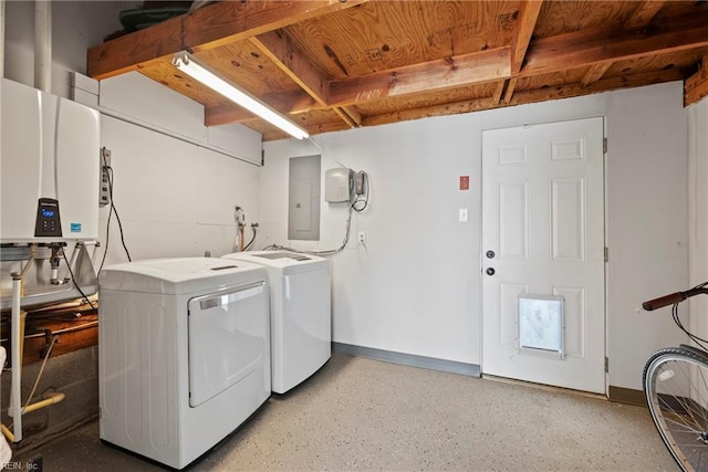 laundry room featuring laundry area, electric panel, baseboards, tankless water heater, and washing machine and dryer