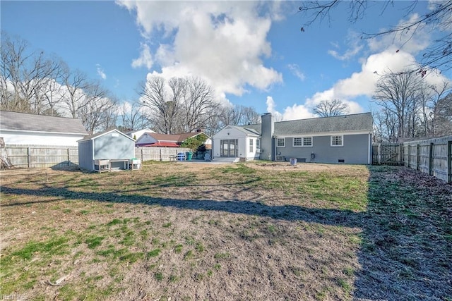 view of yard featuring an outbuilding and a fenced backyard