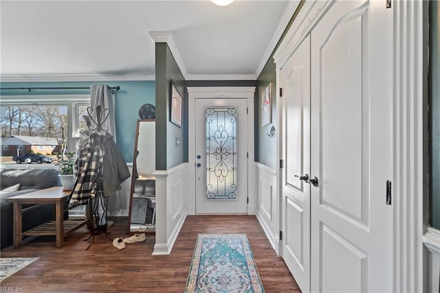 entryway featuring a decorative wall, dark wood-style flooring, wainscoting, and crown molding