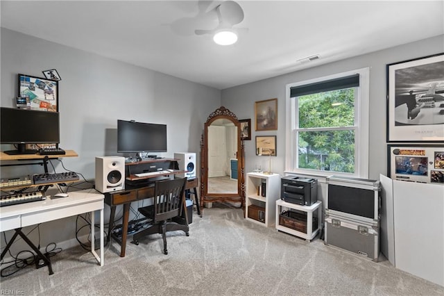 office with carpet floors, visible vents, and ceiling fan