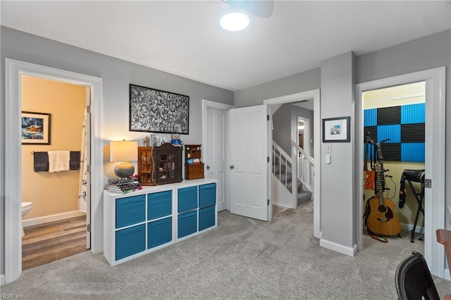 game room featuring baseboards and light colored carpet