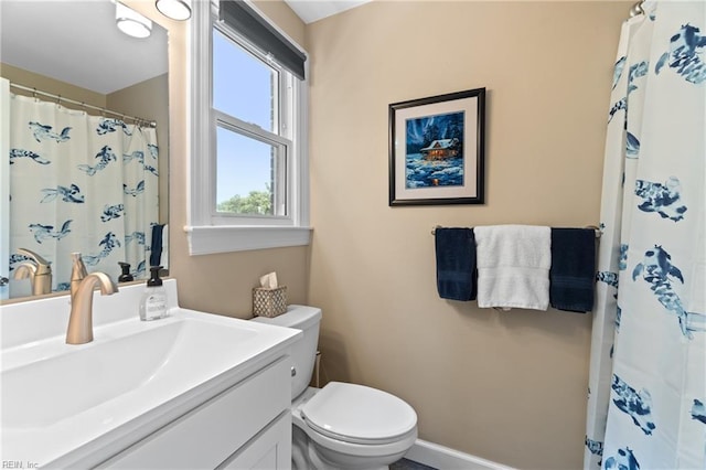 bathroom with a shower with shower curtain, vanity, toilet, and baseboards