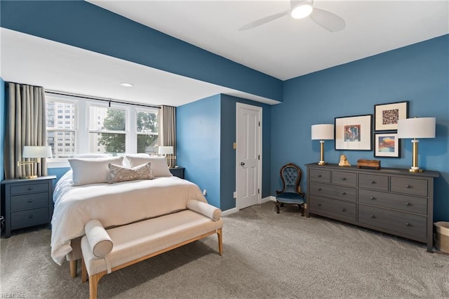 carpeted bedroom with a ceiling fan and baseboards