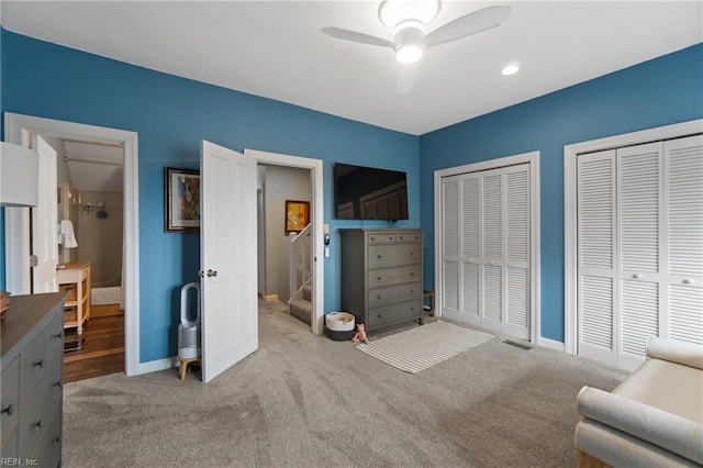 bedroom with baseboards, ceiling fan, carpet, and multiple closets